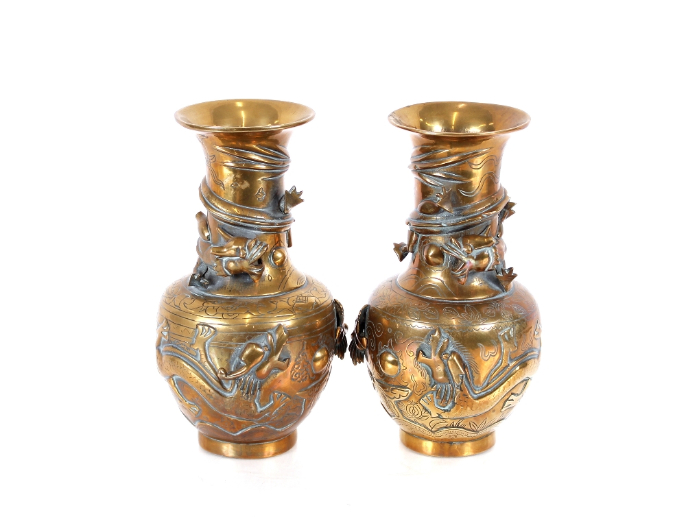 A pair of brass Chinese baluster vases, with raised entwined dragon decoration, 24cm high