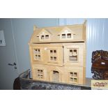 A wooden doll's house lacking contents
