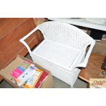 A white painted wicker seat with lift up storage