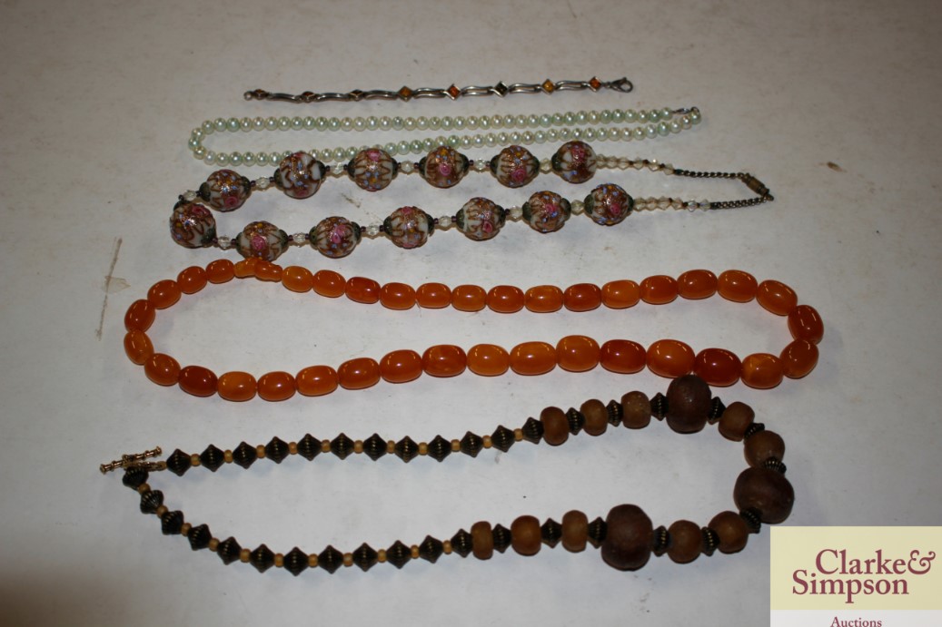 A string of graduated amber coloured beads; a whit