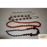A string of graduated amber coloured beads; a whit