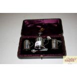 A cased silver three piece cruet by Hamilton & Inc