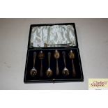 A cased set of six silver coffee spoons and an odd