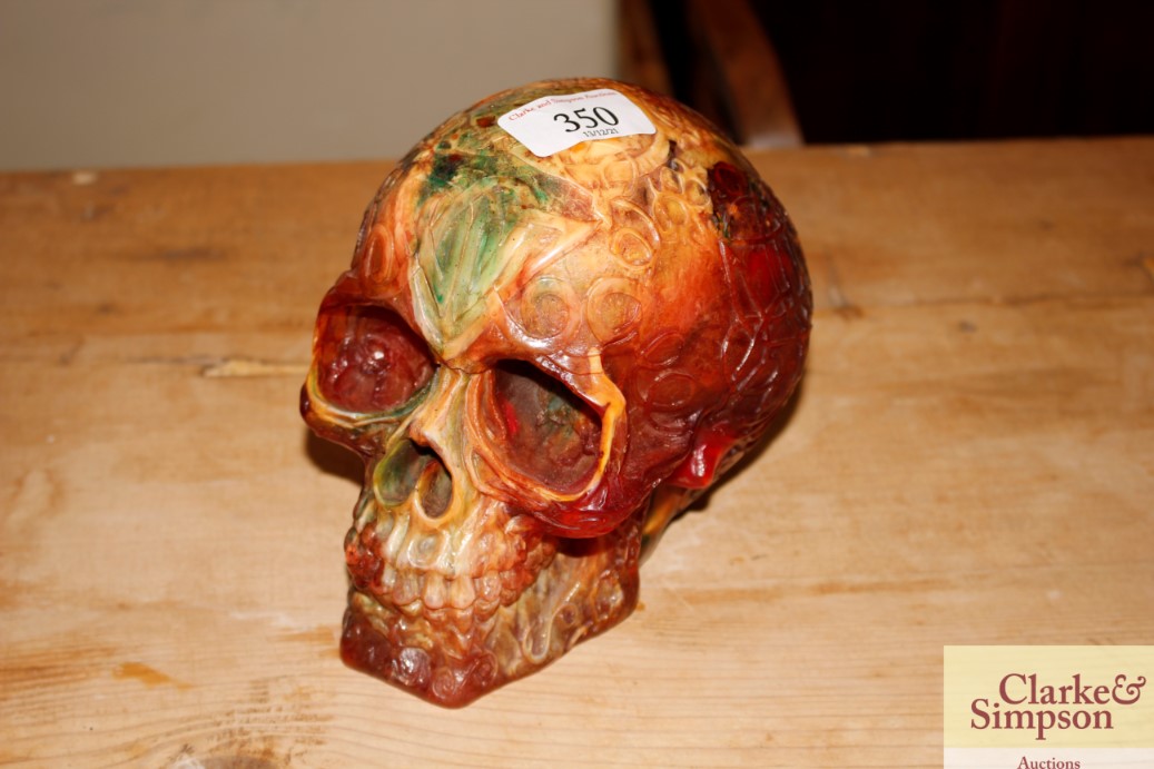 A decorative amber style skull ornament