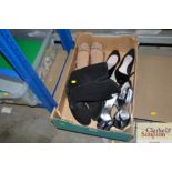 A box of shoes and pair of boots