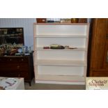 A white painted open bookshelf