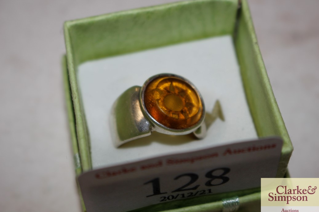 A white metal and amber set dress ring