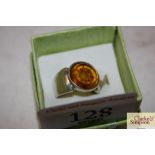 A white metal and amber set dress ring