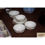 Three rose decorated eggshell tea cups and saucers