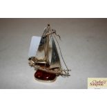 A silver and amber model of a sailing ship