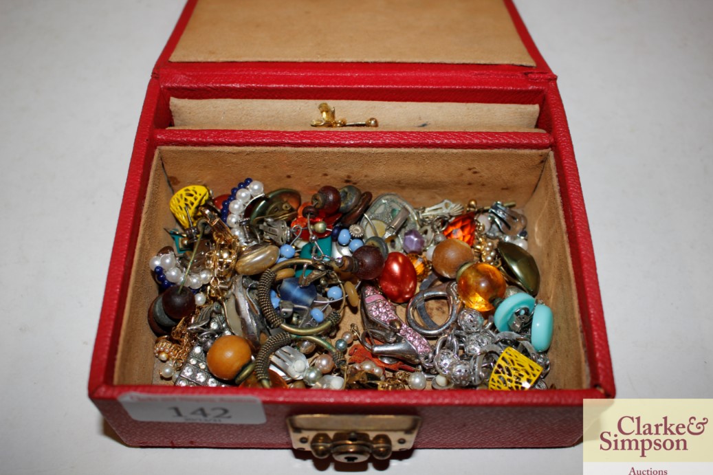 A small red jewellery box containing clip-on ear-r