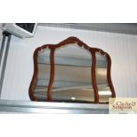 A reproduction mahogany over mantel mirror