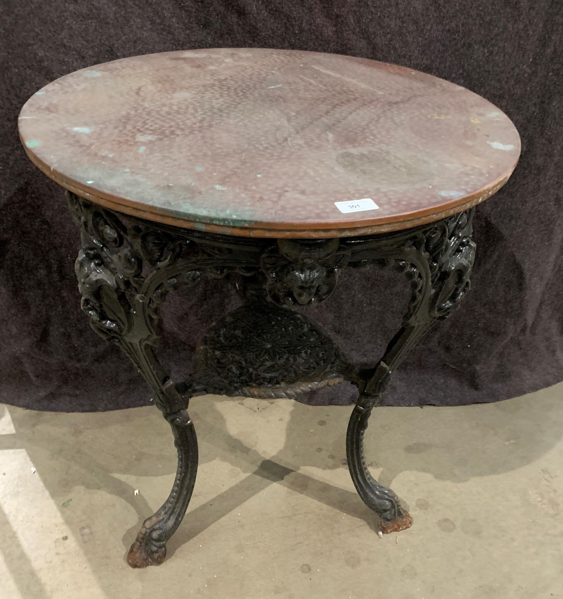 A Kings and Queens cast metal pub table with circular copper top 61cm diameter