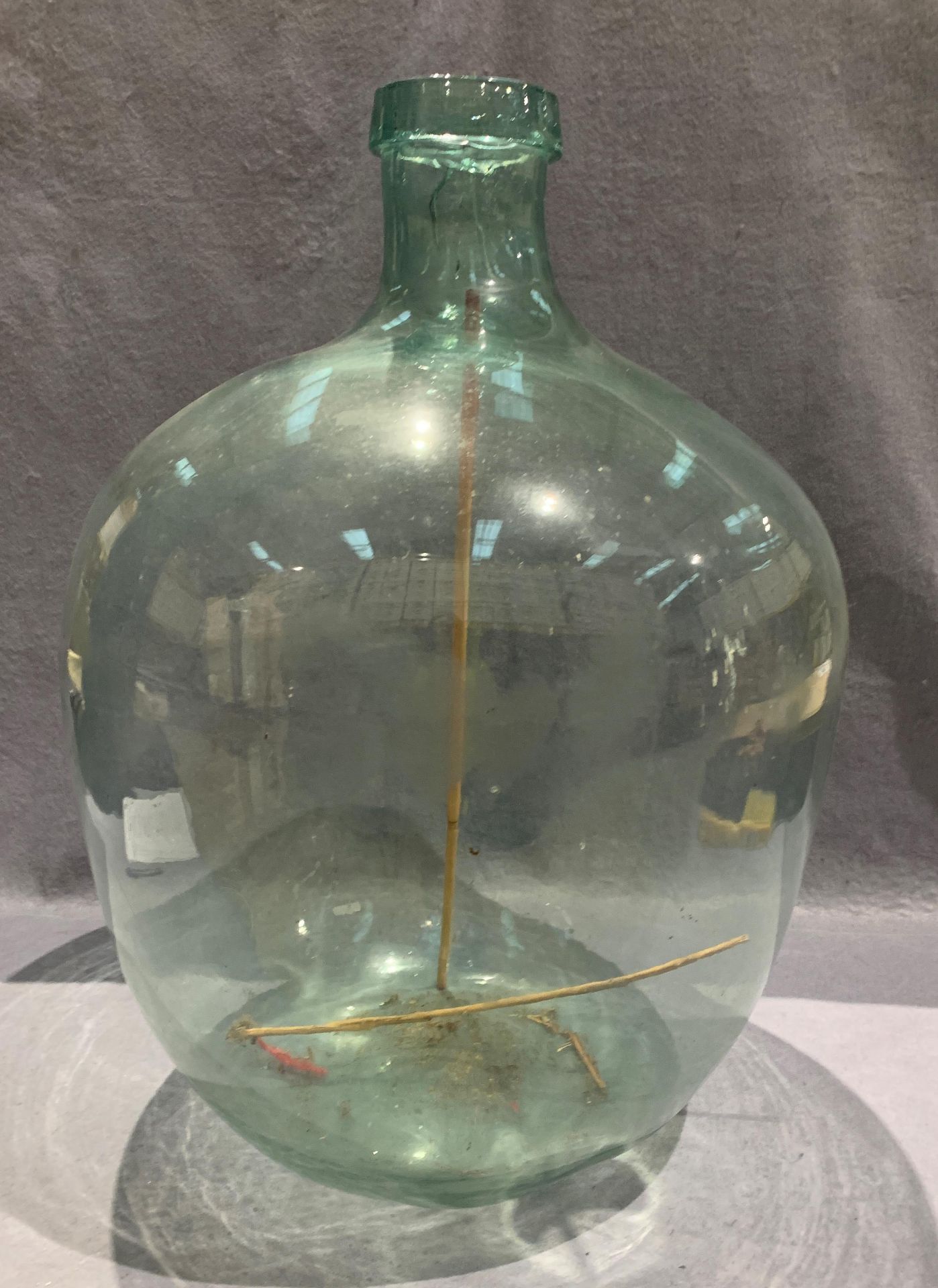 A glass wine flagon approx 65cm high