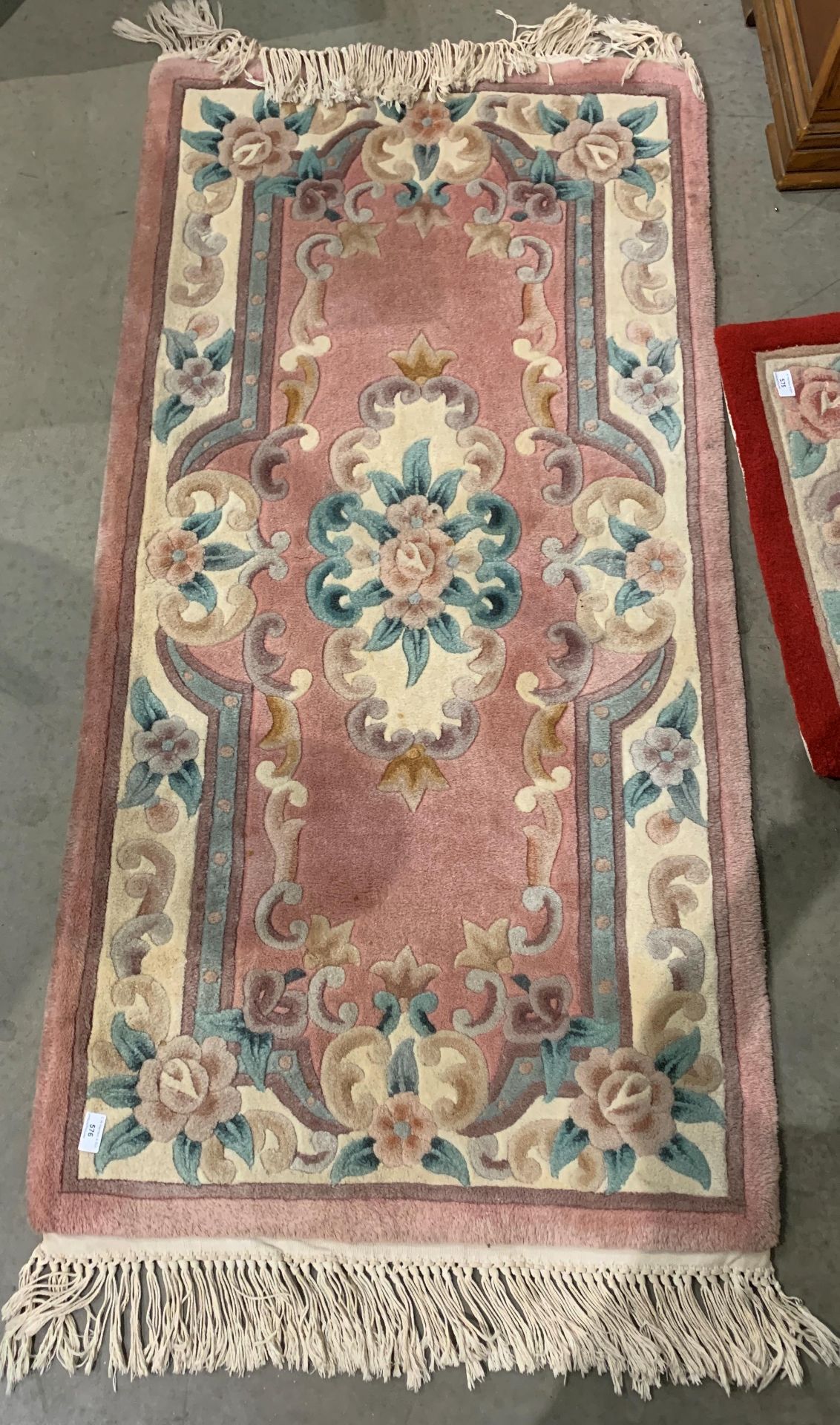 A pink patterned Chinese rug,