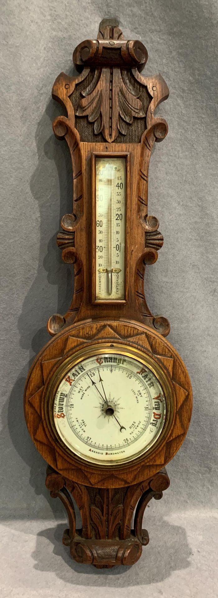 An oak cased Aneroid wall barometer 63cm