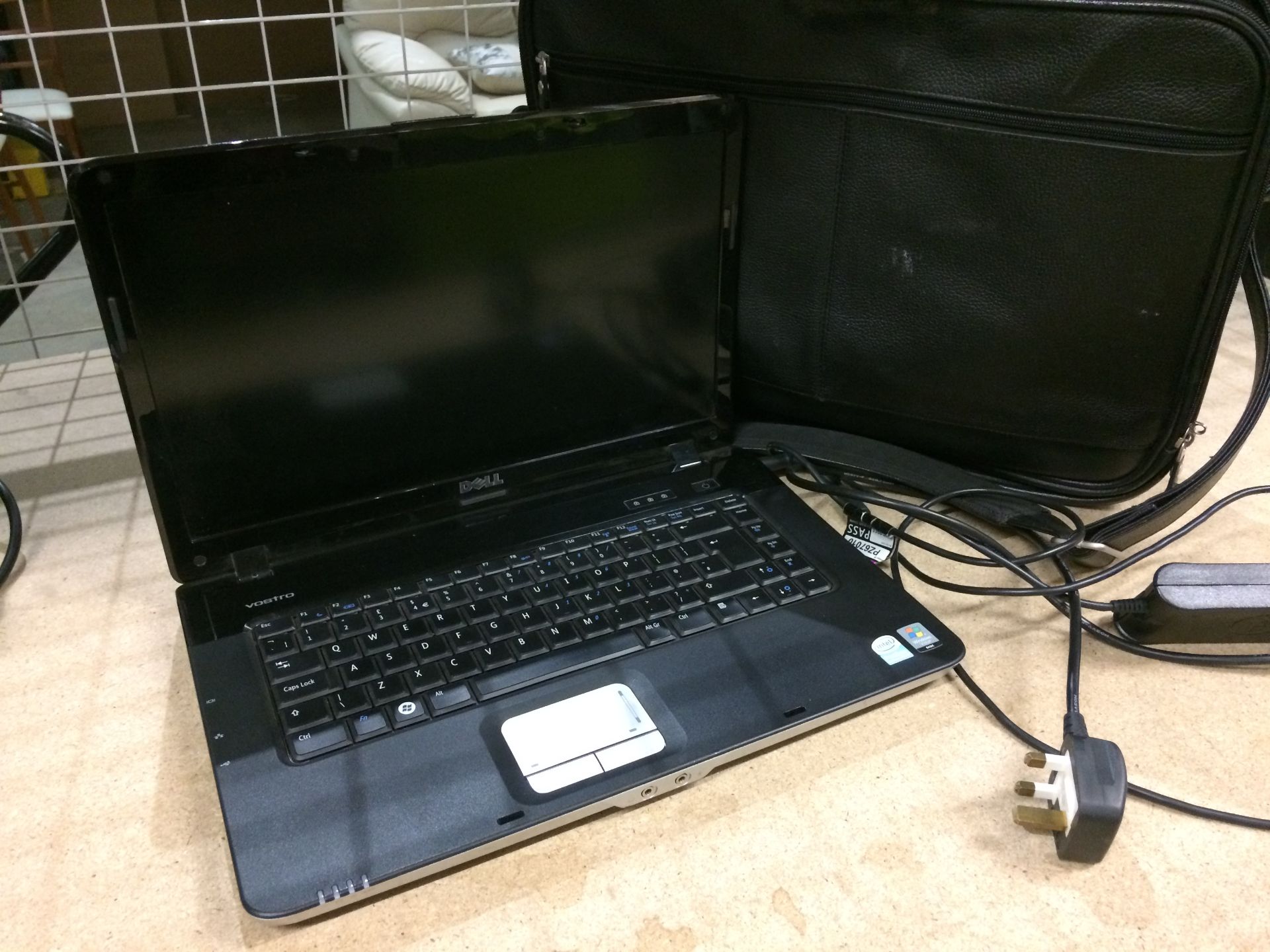 A Dell Vostro PP37 notebook computer complete with adapter and black vinyl laptop bag