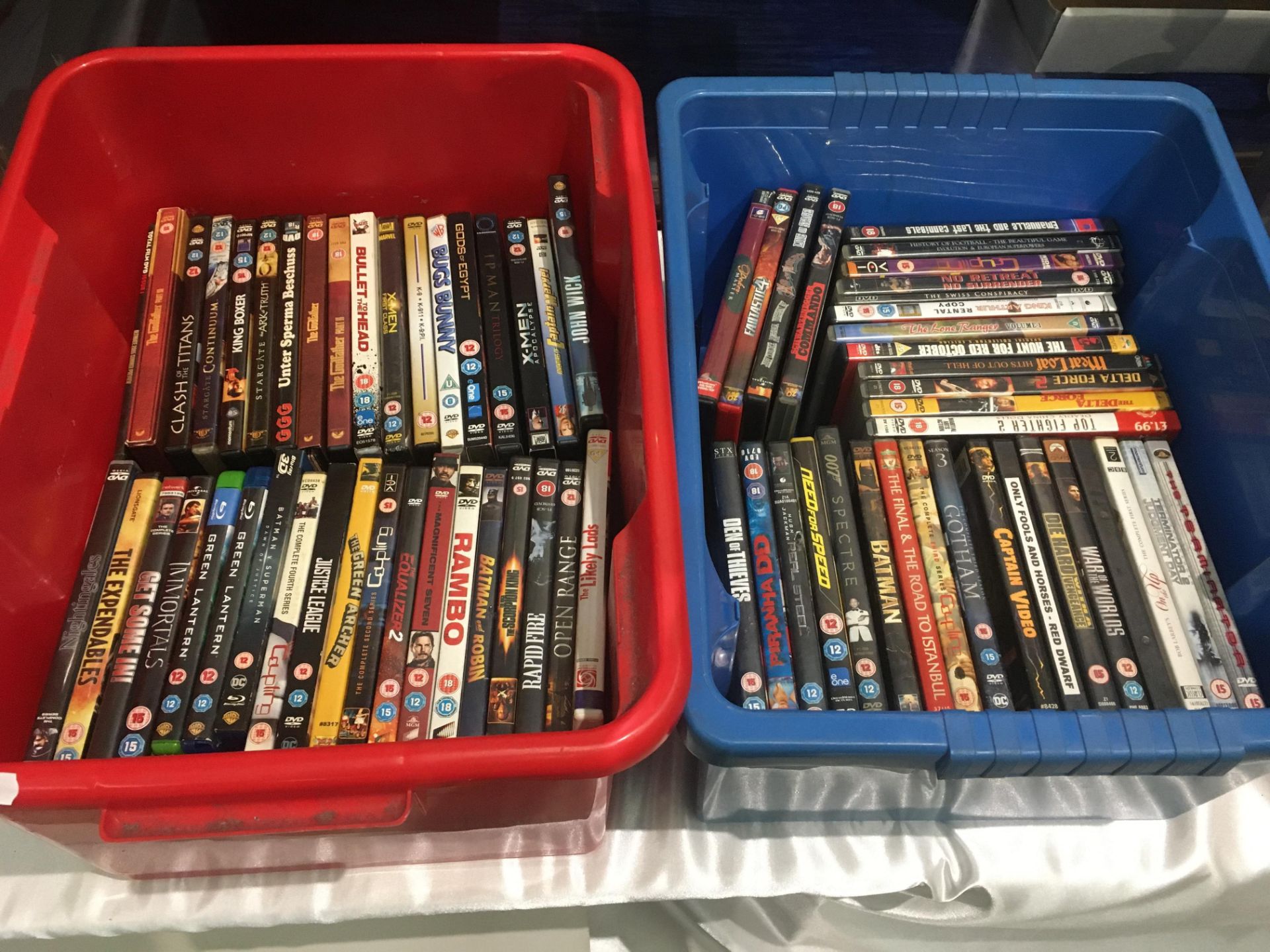 Contents to two boxes - approximately 70 x DVDs - Rambo, Batman, Bugs Bunny,