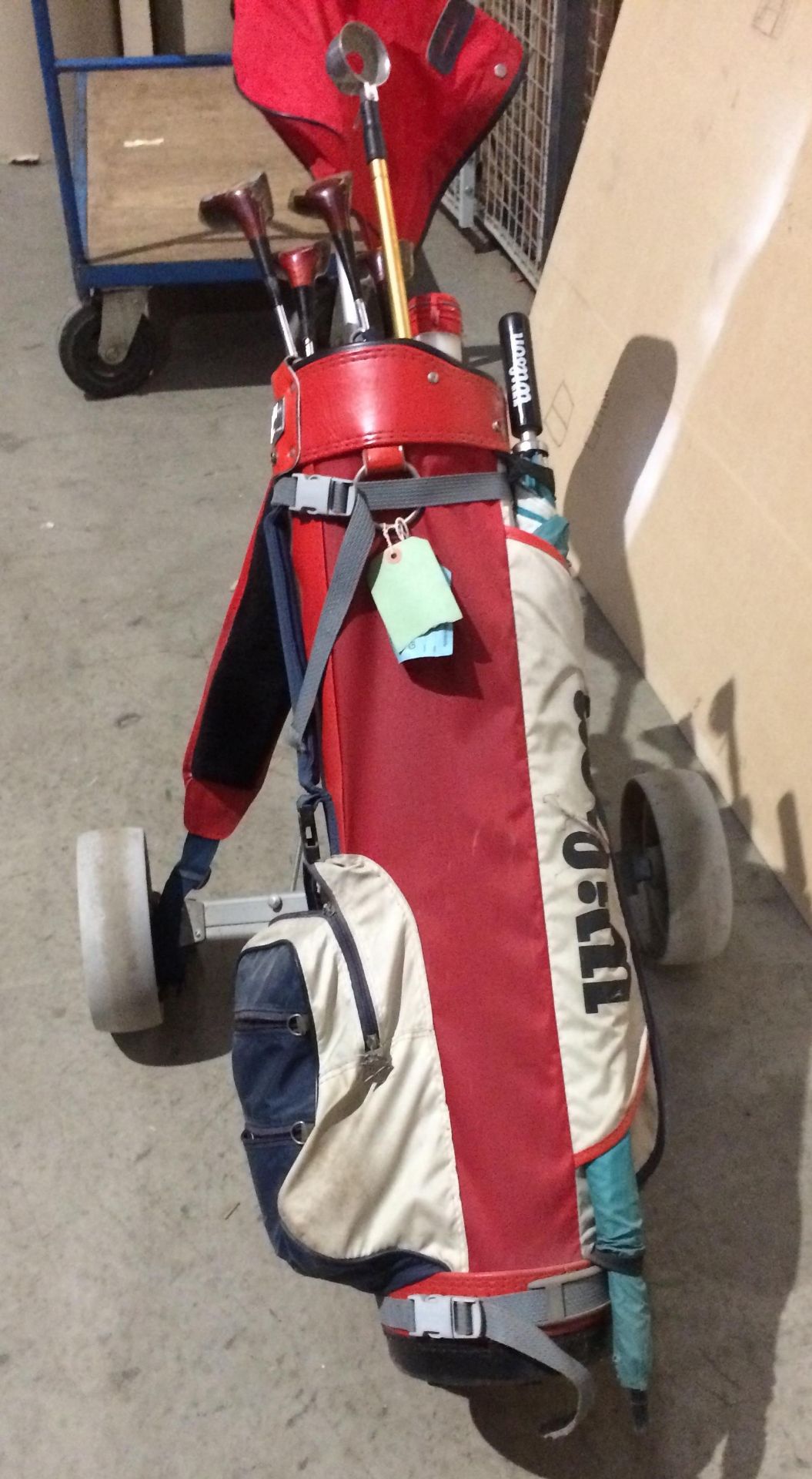 A Titleist golf trolley, Wilson golf bag, 4 x Ryder woods, golf ball retriever,