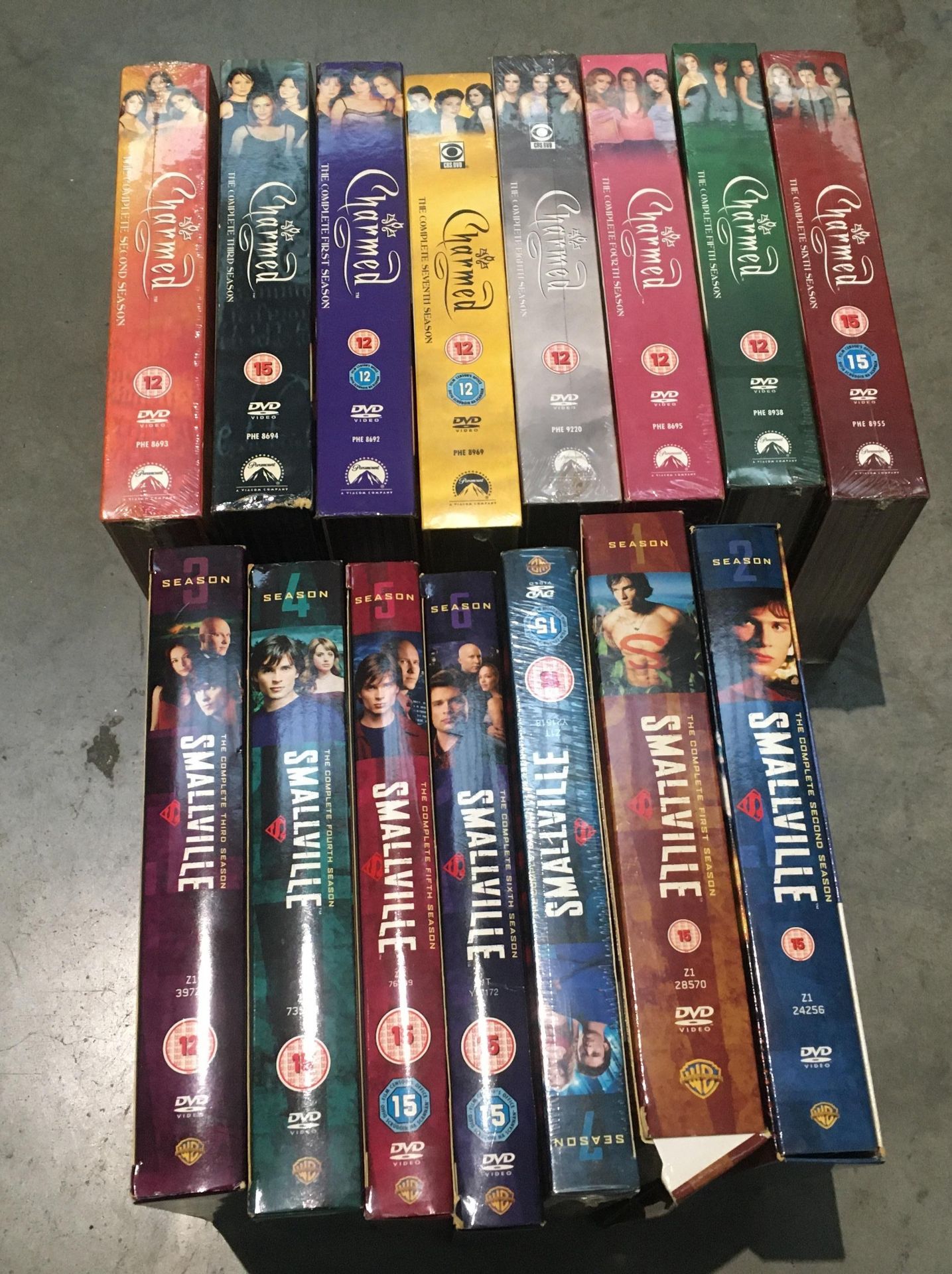 15 x DVD box sets - 8 x Charmed and 7 x Smallville