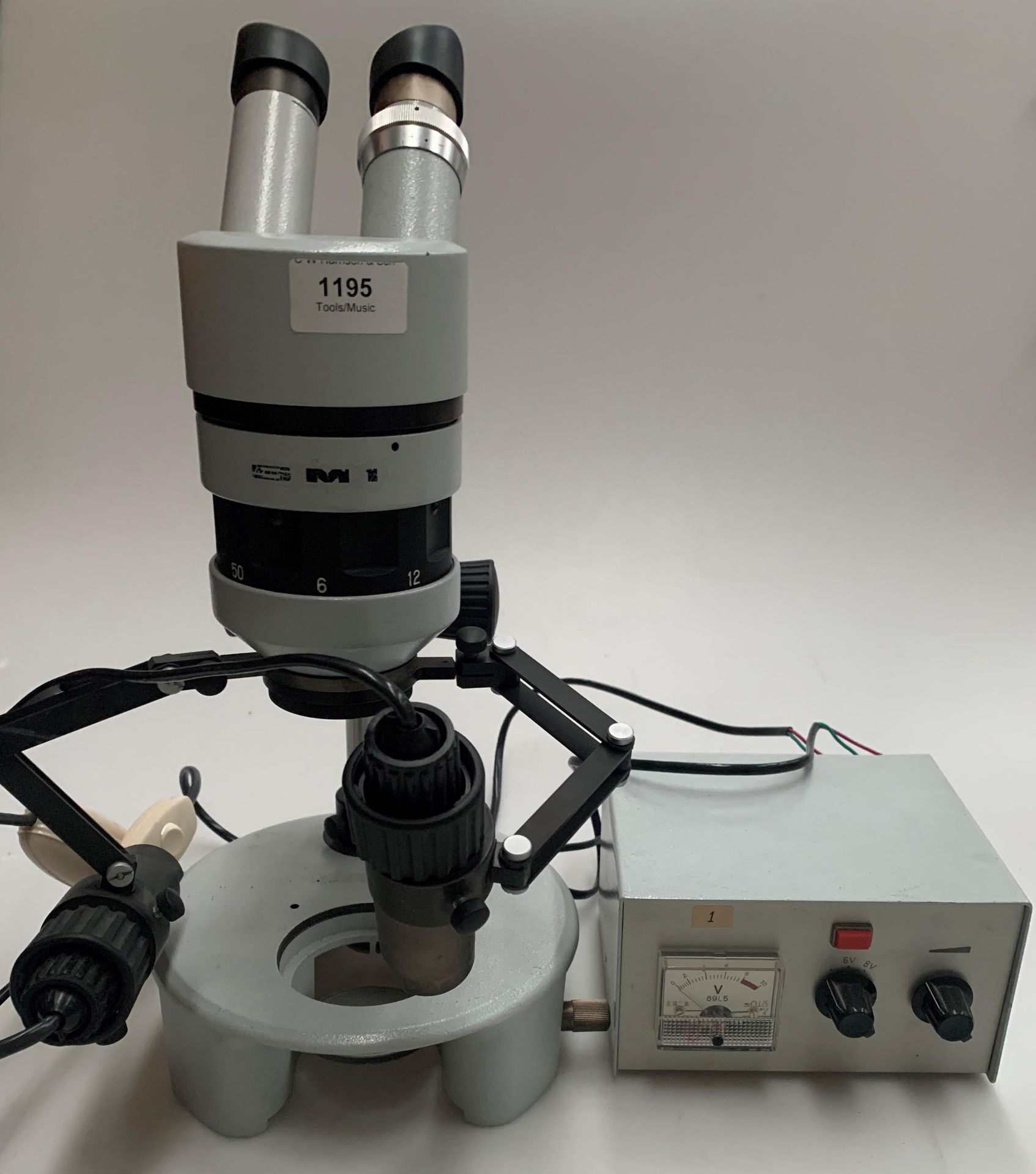 An SMI laboratory microscope complete with control box and cover