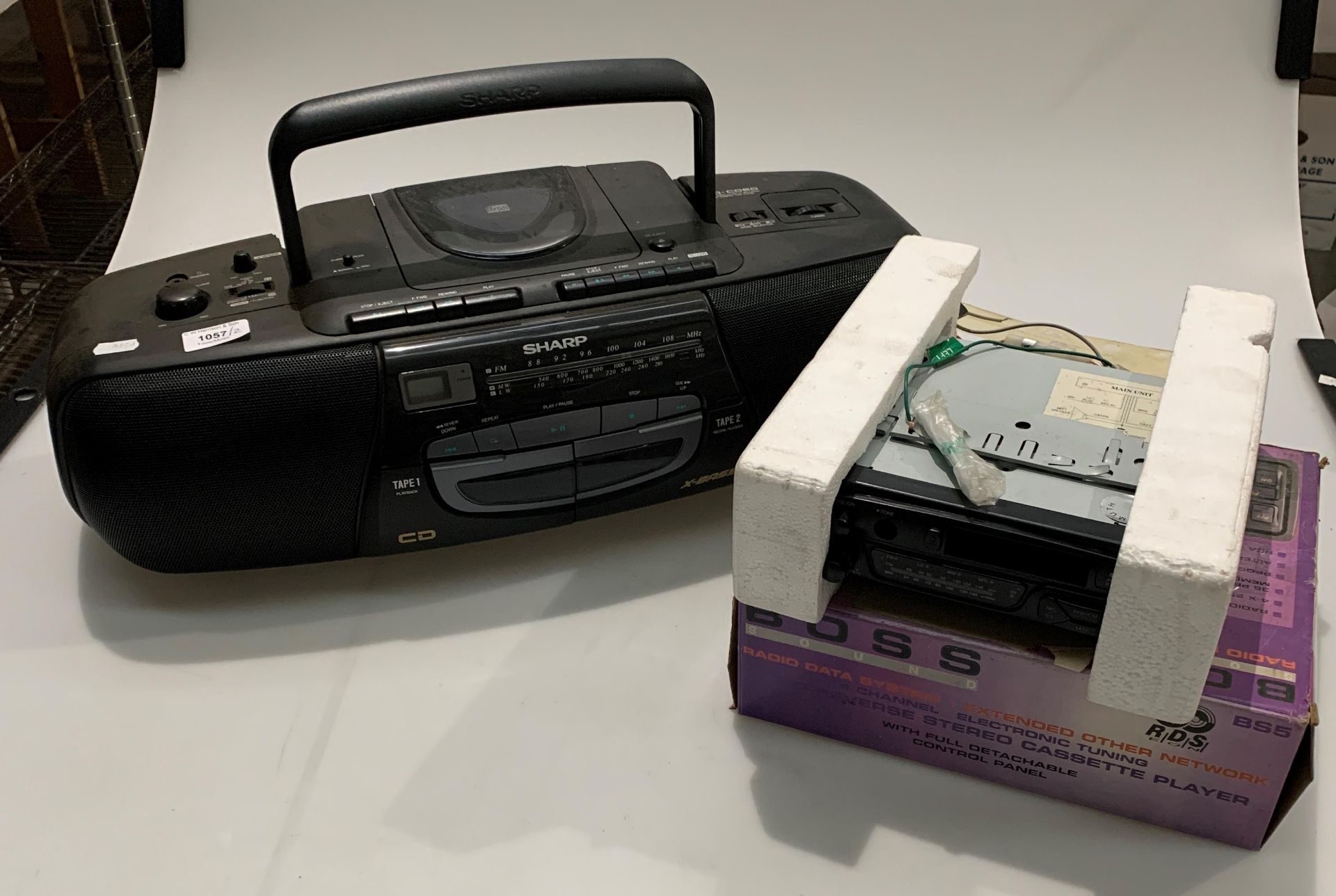 A Harvard car radio/cassette player in non matching Boss box and a Sharp WQ-C060 portable stereo