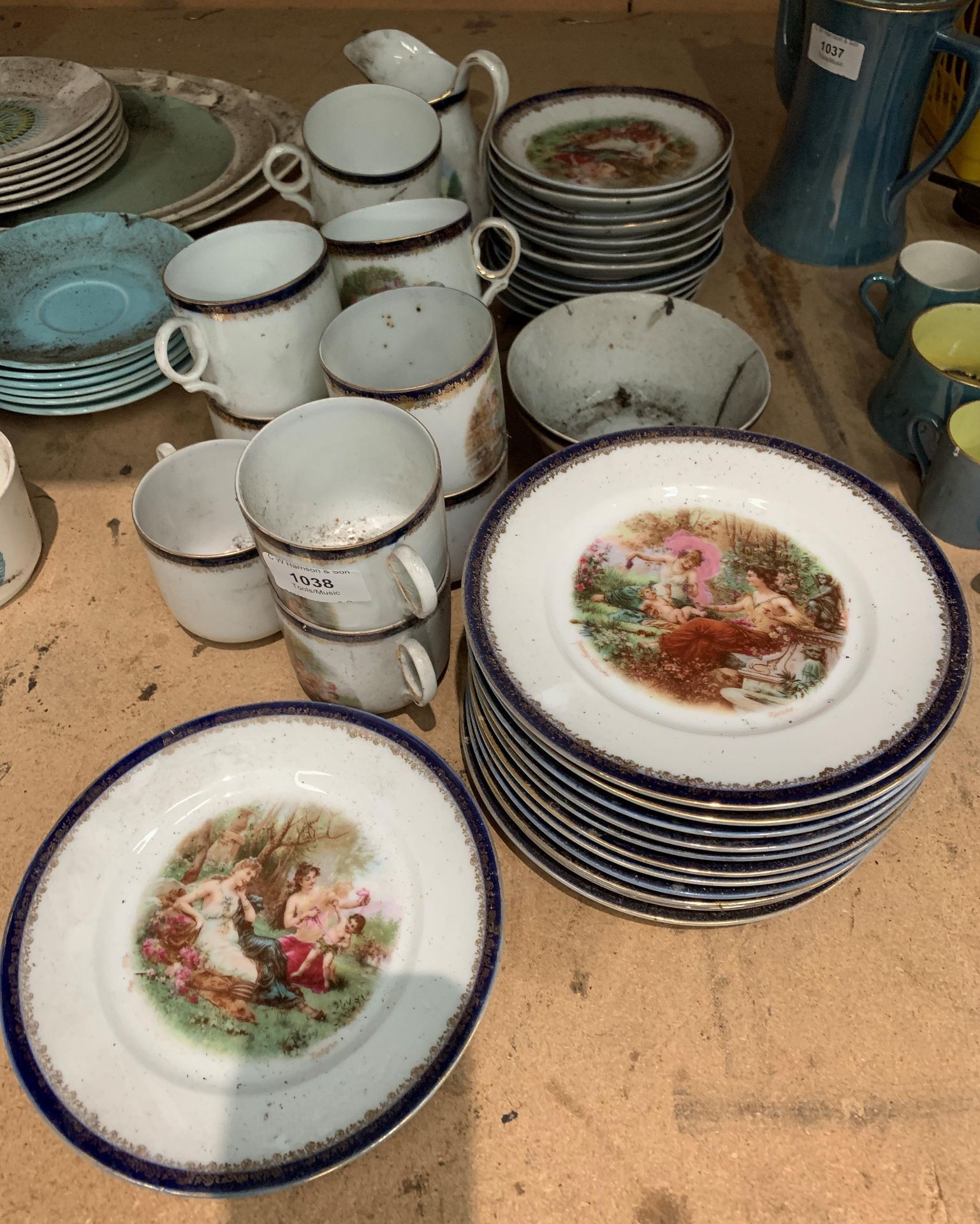 Thirty-seven piece part tea service decorated with scenes of ladies with children