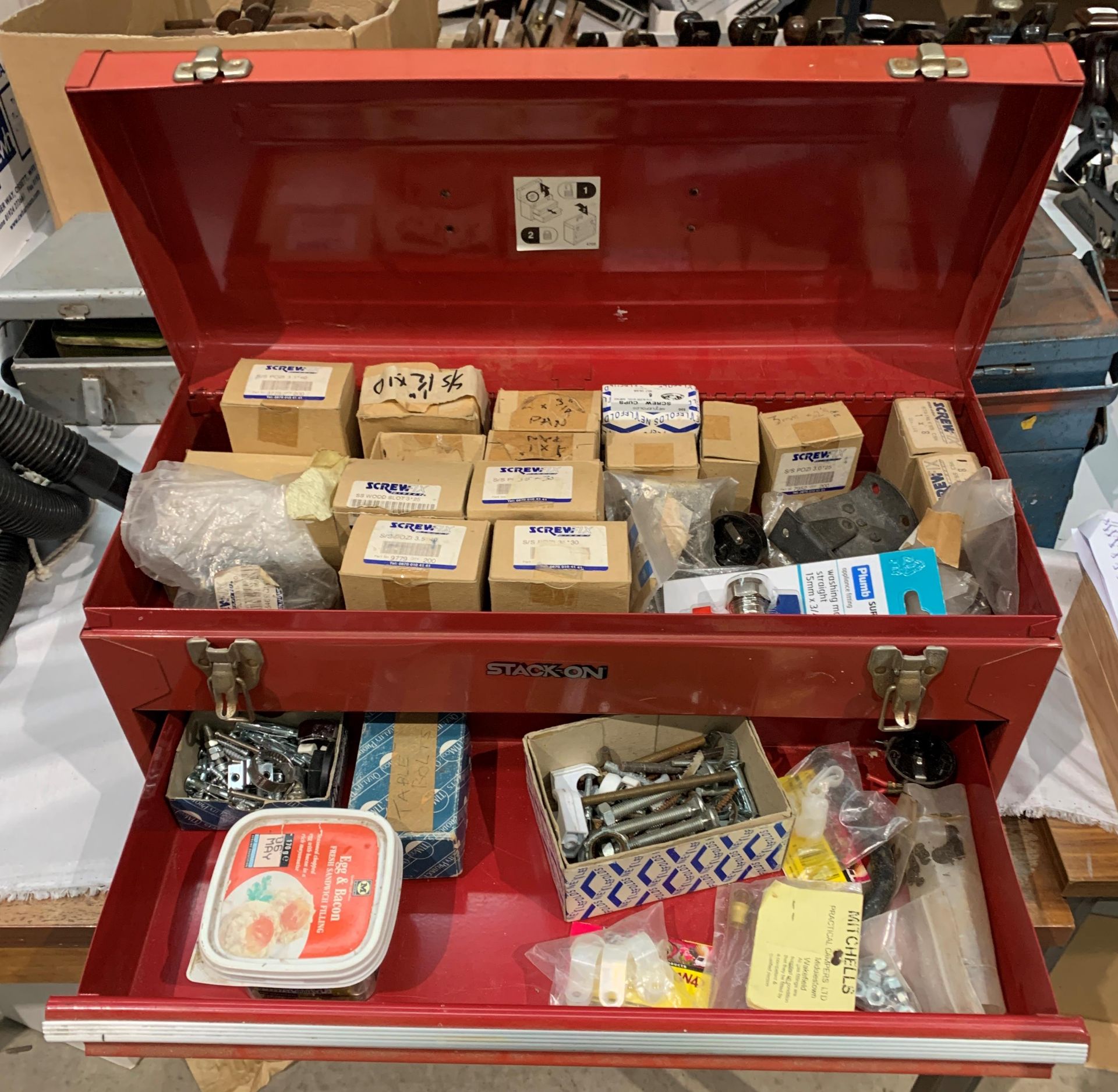 A Stack On red metal tool box and contents - part boxes of Screwfix wood screws,