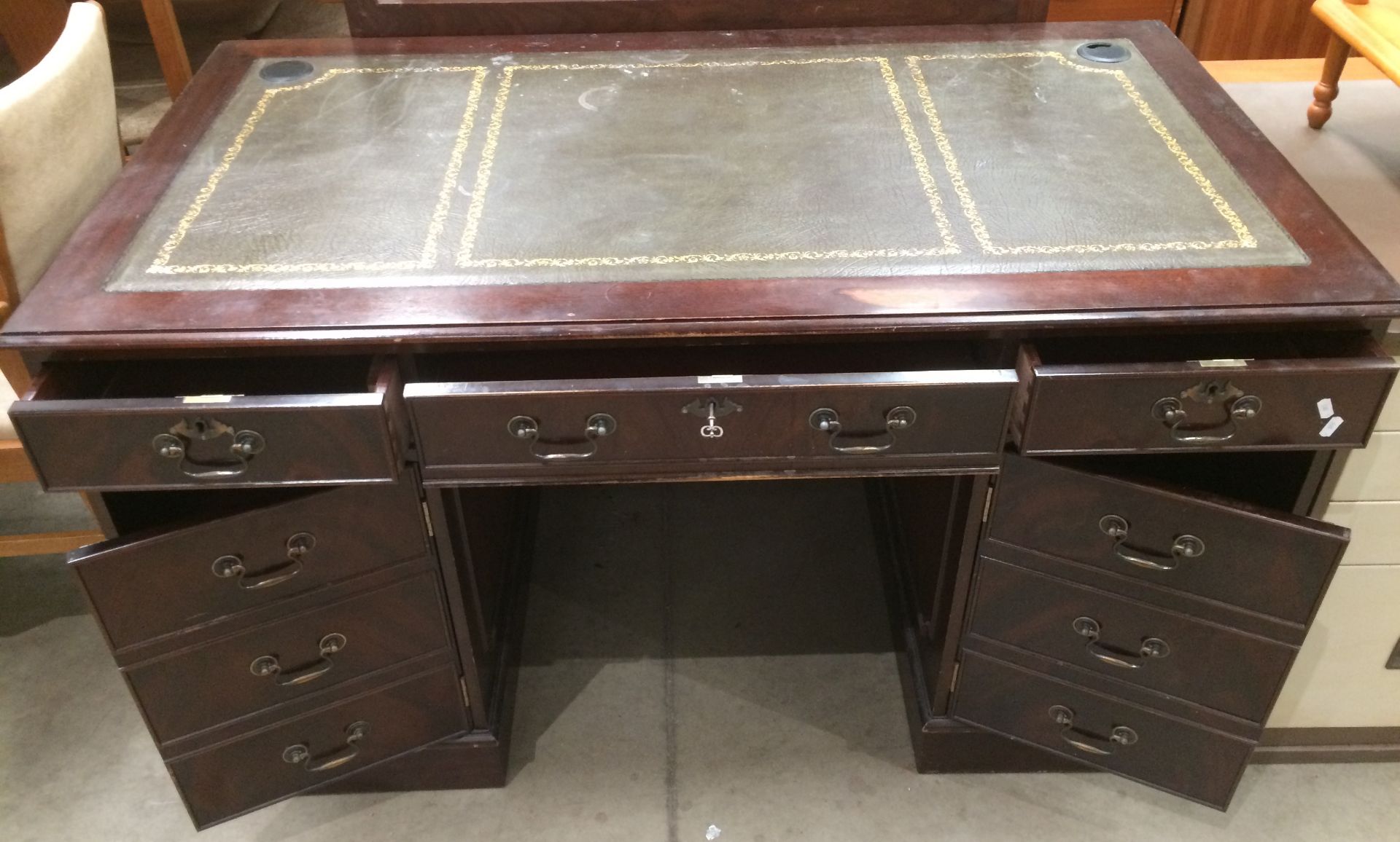 A mahogany finish reproduction two door (each with 3 dummy drawers) three drawer twin pedestal desk