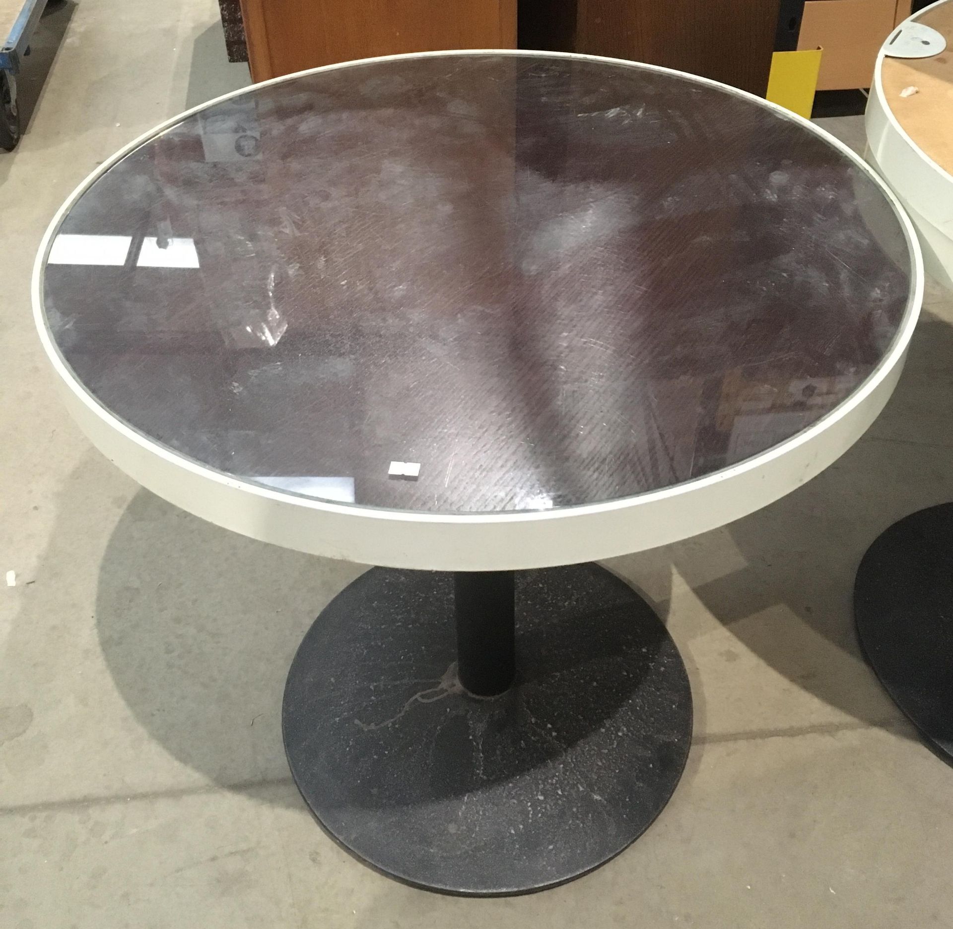 Glass topped circular table 81.