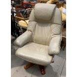 A cream leather finish swivelling studio armchair (upholstery marked)