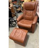 A medium brown reclining armchair with matching lift top stool/side table