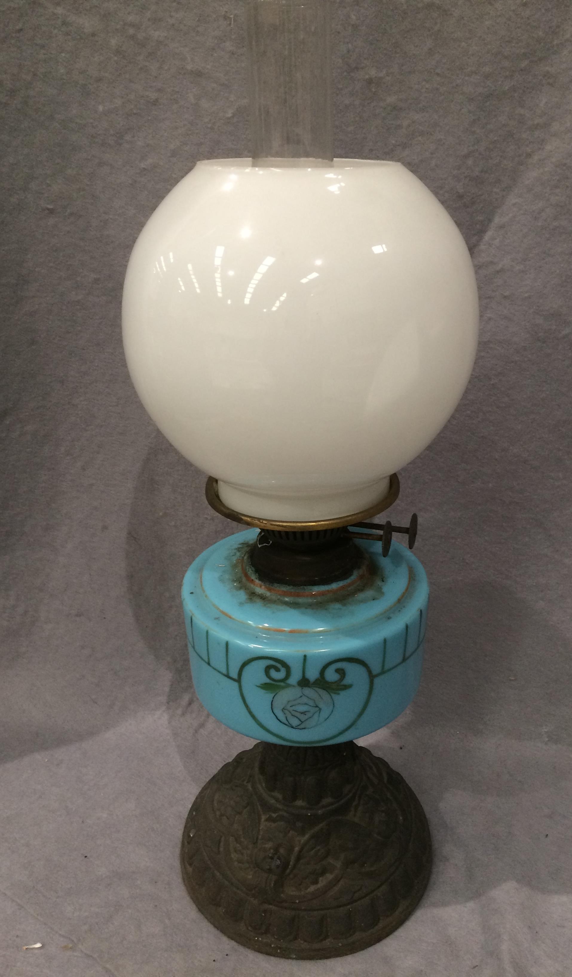 A metal and painted blue glass oil lamp with white glass shade (minor chips to rim) and glass