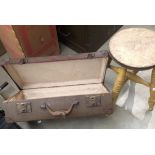 A painted stool and a brown fibre suitcase