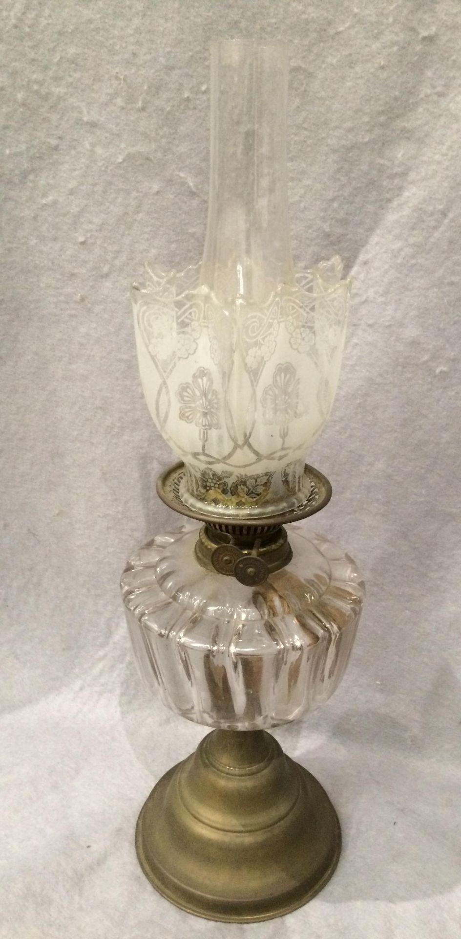 A brass and glass oil lamp with etched glass shade and funnel,