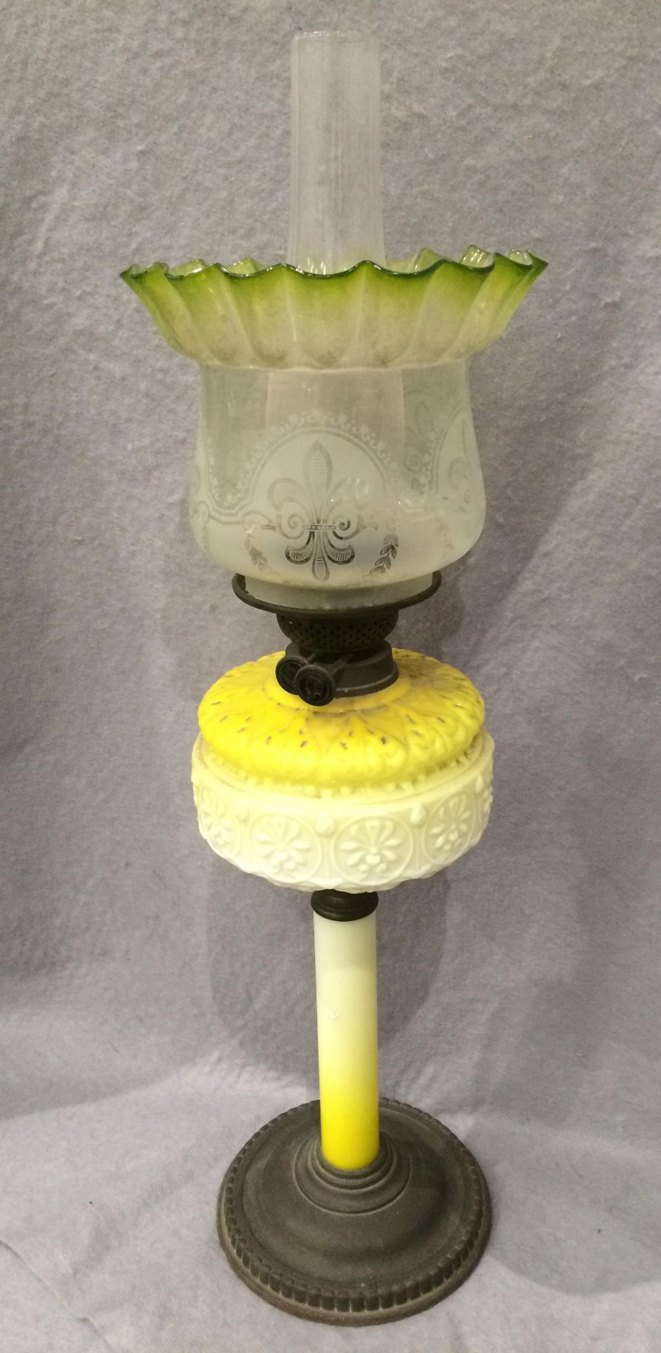 A brass and yellow and cream glass oil lamp with etched glass shade and funnel,
