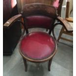 A bentwood armchair with red vinyl seat