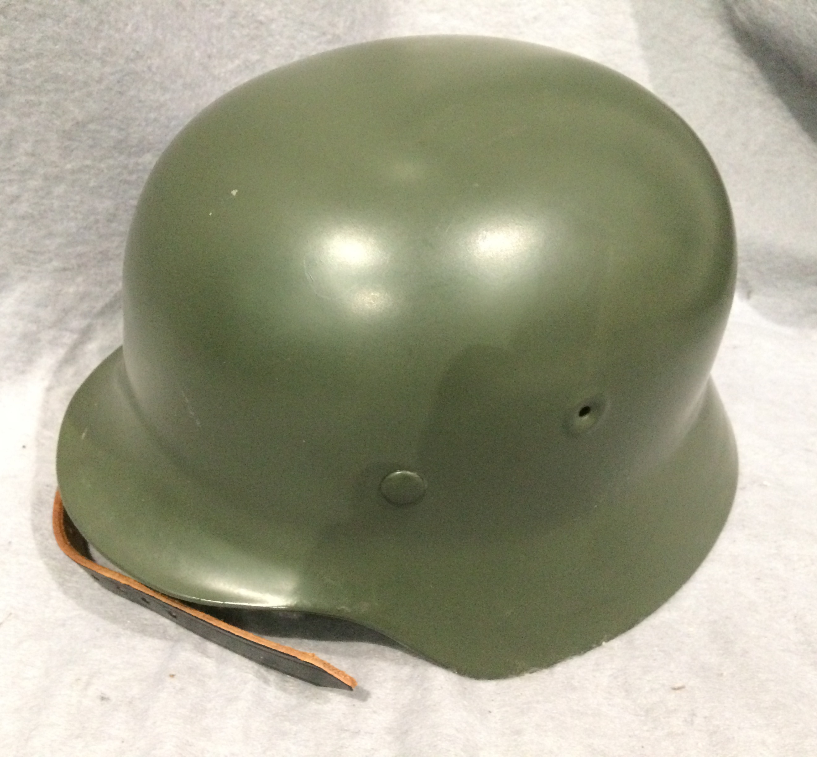 A reproduction green metal 'German' mili