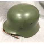 A reproduction green metal 'German' mili