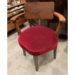 A stained oak framed shaped armchair wit