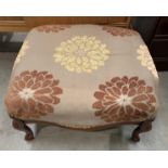 A reproduction mahogany framed stool with brown patterned upholstery