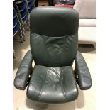 An Ekornes green leather swivelling stud