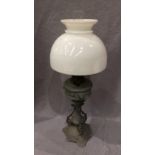 A grey painted ornate oil lamp with white and clear glass shade and glass funnel, 65cm high,