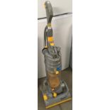 A Dyson DC04 upright vacuum cleaner complete with attachments