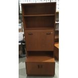 A G-Plan teak wall unit with two open shelves over fall front door and two door base,