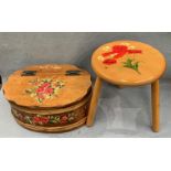 A three legged wood stool with floral pattern to top and a floral pattern painted wood box with