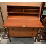 A teak bureau with fall flap over three drawers,
