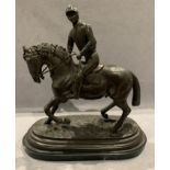 A reproduction bronze equestrian statue in the style of Jules Mane, on a marble base,