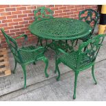 A green painted aluminium circular patio table 106cm dia and four matching armchairs