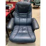 A Unico distressed dark blue leather finish swivelling studio armchair